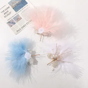 Close-up of handmade feather hair clips with crystal beads and pearls, DIY hair accessory details.