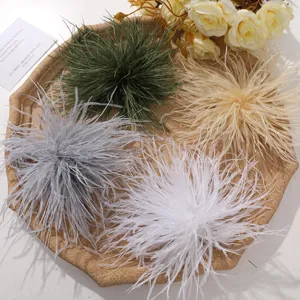 Close-up shot of fluffy ostrich feather flowers in various colors arranged on a vintage tray.