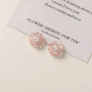 Close-up of handmade pink crystal flower pearl earring DIY accessories detail shot.