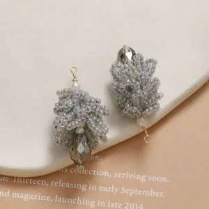 Detailed close-up of handmade beaded crystal pinecone pendants with faceted drops.