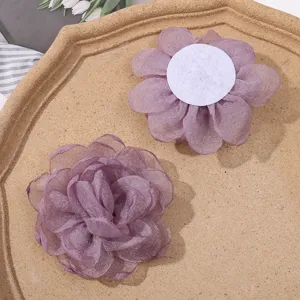 Organza burnt edge flower detail showing front petals and back adhesive pad for DIY hair accessories.