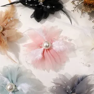 Close-up detail of multi-color DIY mesh flower feather pearl accessories for headwear crafts.