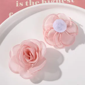 Pink mesh fabric flower DIY material detail, showing multi-layer sheer rose design and backing.