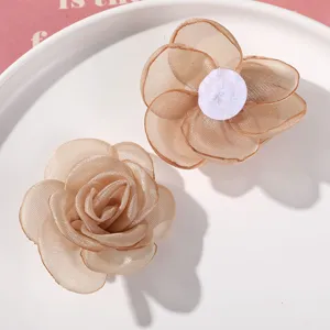 Detail view of champagne sheer mesh flower DIY hair accessories, showing front and back.