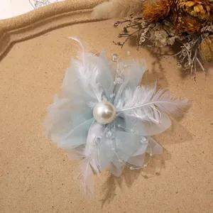 Fairy mesh flower hair accessory with white feathers, large pearl, and delicate bead chains.