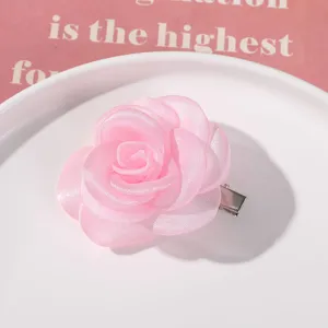 Pink mesh flower hair clip detail showing delicate organza rose petals and metal clip.