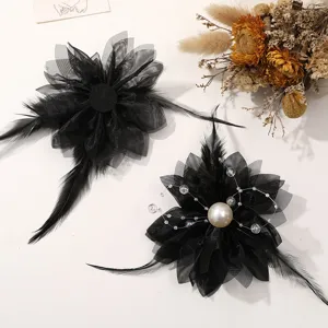 Detail view of black mesh feather flower DIY hair accessories with pearl and delicate tassels.