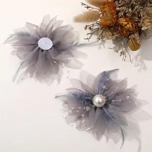 Grey mesh flower DIY hair accessory with pearls, feathers and beads for detailed view.