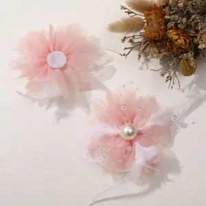 Pink tulle flower DIY hair accessories featuring elegant pearls, soft feathers and delicate beads.