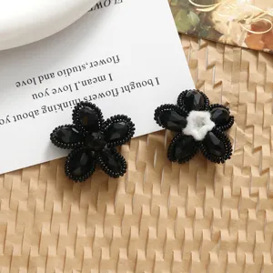 Close-up detail of black crystal beaded woven flower DIY handmade pendant jewelry parts.