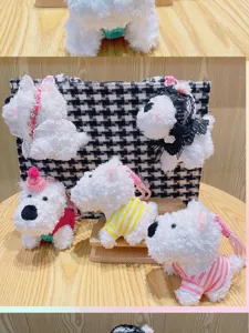 Cute West Highland white dog plush pendant detail view, soft fluffy keychain doll decoration.