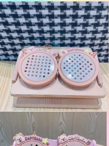 Closeup of cute capybara magnetic steel ball drawing board keychain, pink mini toy pendant.
