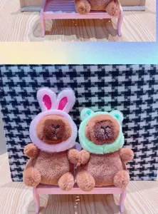 Cute capybara plush toy keychain with lovely rabbit and frog hats, soft stuffed doll pendant.