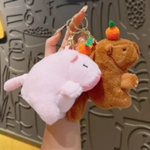 Cute capybara plush keychain with orange charm, soft animal bag pendant and toy accessory.