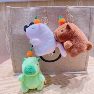 Cute capybara plush keychain with orange on head, soft stuffed animal bag charm toy.