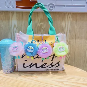 Cute cartoon plush bear keychain canvas tote bag with colorful fluffy ball pendants for women.