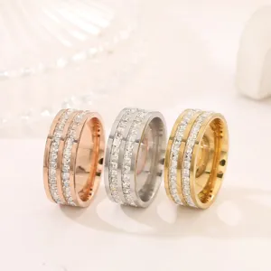 Detail view of wide stainless steel rings featuring double rows of sparkling square zirconias.