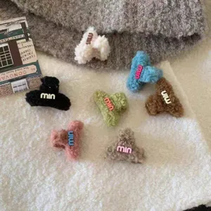 Plush hair claw clips for women, cute winter fuzzy shark clips with letter designs.