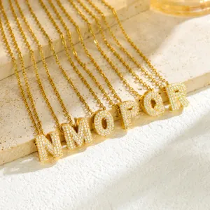 Gold initial letter pendant necklace micro-paved cubic zirconia alphabet jewelry detail.