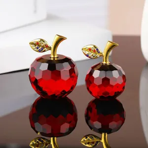 Exquisite red crystal apple figurine set with gold stem and sparkling rhinestone leaves for home decor.