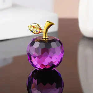 Detailed view of a purple crystal apple ornament with gold stem and rhinestones for decor.