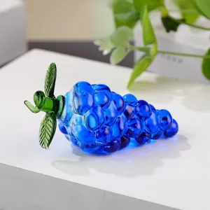Crystal glass blue grape fruit figurine ornament with vibrant green leaves detail shot