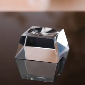 Detail view of transparent crystal ball base, trapezoid faceted glass stand for sphere.