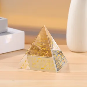 Detailed view of the crystal pyramid ornament featuring golden Egyptian hieroglyphs.