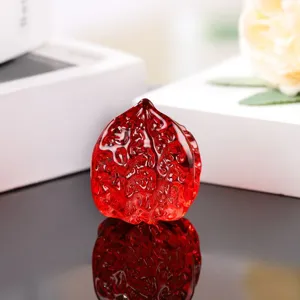 Red glass walnut sculpture detail shot, exquisite carved texture, elegant decorative ornament.