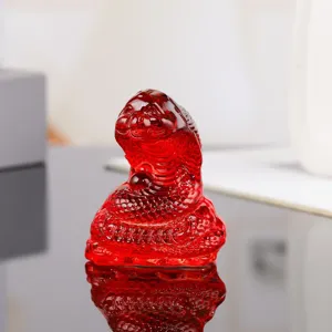 Close up of red crystal zodiac snake figurine detail, sleek glass texture for home decor.