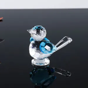 Exquisite crystal glass blue bird figurine detail shot, sparkling multi-faceted ornament.