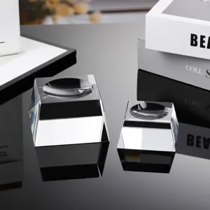 Close-up detail of clear crystal ball bases, featuring faceted trapezoidal glass stands for display.