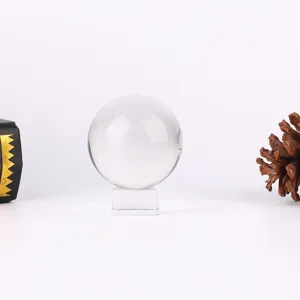 Transparent crystal glass ball with square stand for elegant home decor and tabletop display.