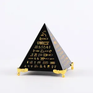 Exquisite black crystal pyramid ornament with gold ancient Egyptian hieroglyphs on stand.