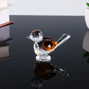 Exquisite crystal bird figurine with multi-faceted design and warm amber wings for home desktop decor.