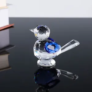 Crystal glass bird figurine detail showcasing faceted blue crystal wings and clear body.