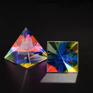 Crystal pyramid ornament with laser engraved castle pattern and rainbow refraction light effect.
