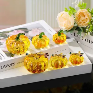 Crystal glass pumpkin figurine detail shot, transparent yellow decor piece for autumn display.