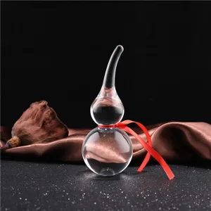 Detailed shot of a transparent crystal gourd ornament with a red ribbon, elegant decor.