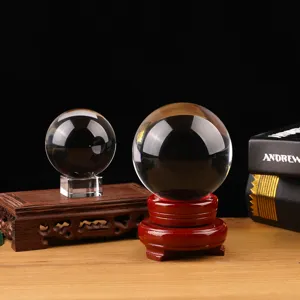 Detailed view of clear crystal glass sphere featuring elegant wooden and crystal stands.