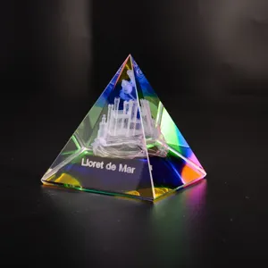 Exquisite crystal pyramid ornament featuring laser-etched castle detail and colorful refraction light.