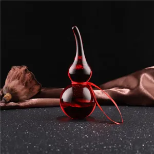 Red crystal gourd ornament detail showcasing smooth glass texture and festive red ribbon decor.
