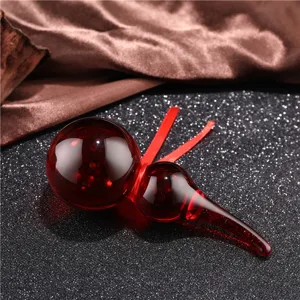 Detailed close-up view of the elegant red crystal gourd ornament, showing smooth surface.