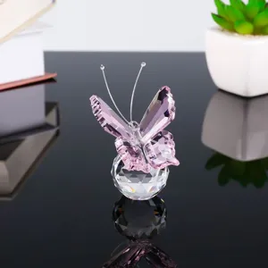 Pink crystal butterfly figurine on a crystal ball base, exquisite tabletop home decor detail.