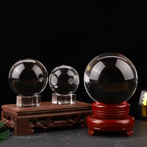 Detail view of transparent crystal glass balls with wooden bases for home decor ornaments.