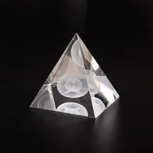 Detailed view of the crystal pyramid ornament featuring laser-engraved 3D geometric interior art.
