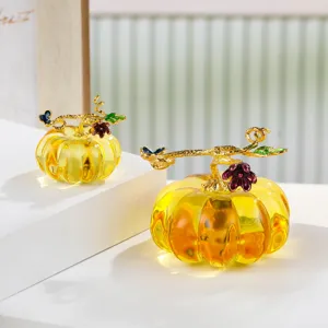 Detail view of crystal glass pumpkin figurine with gold vine decor for autumn home decor