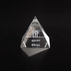 Clear crystal pyramid figurine featuring laser-etched Egyptian figures and text detail