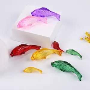 Detailed view of colorful crystal glass fish figurines, vibrant translucent home decor set.