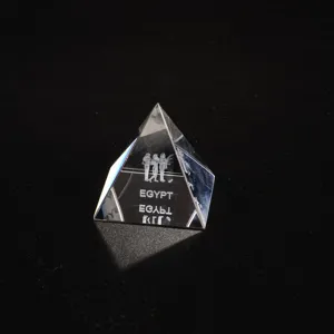 Detailed view of the crystal pyramid figurine showcasing laser-etched Egyptian figures and text.